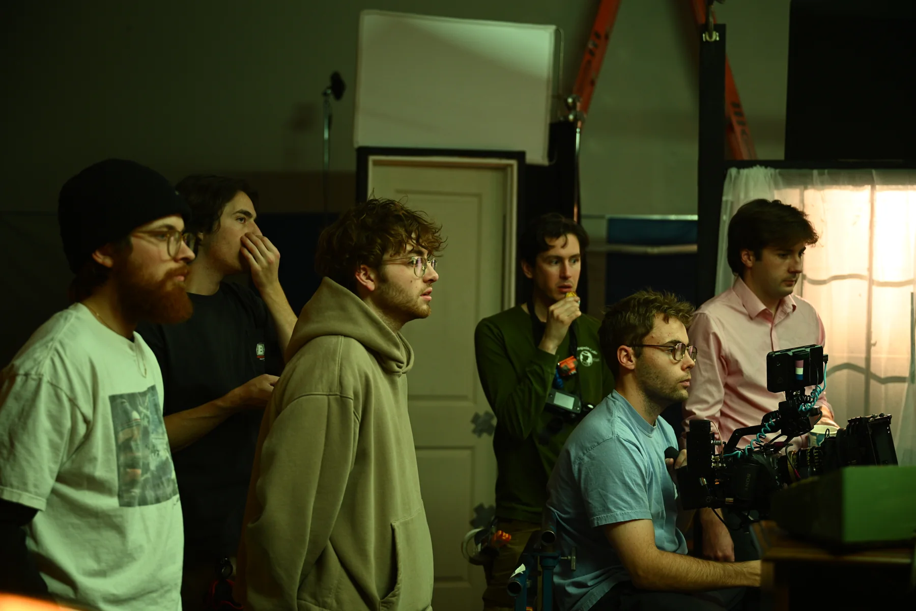 The crew works together around the set and monitor.