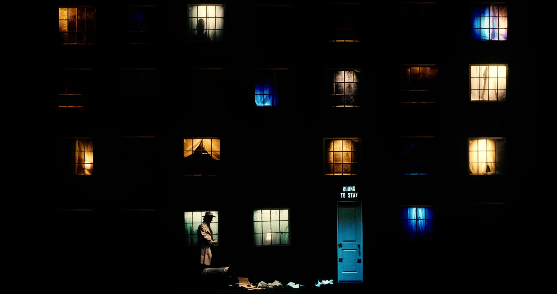 Isolated windows and miniature rooms float in an underground city.